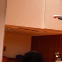 trent james comedy magician at sibs and kids with student holding a balloon